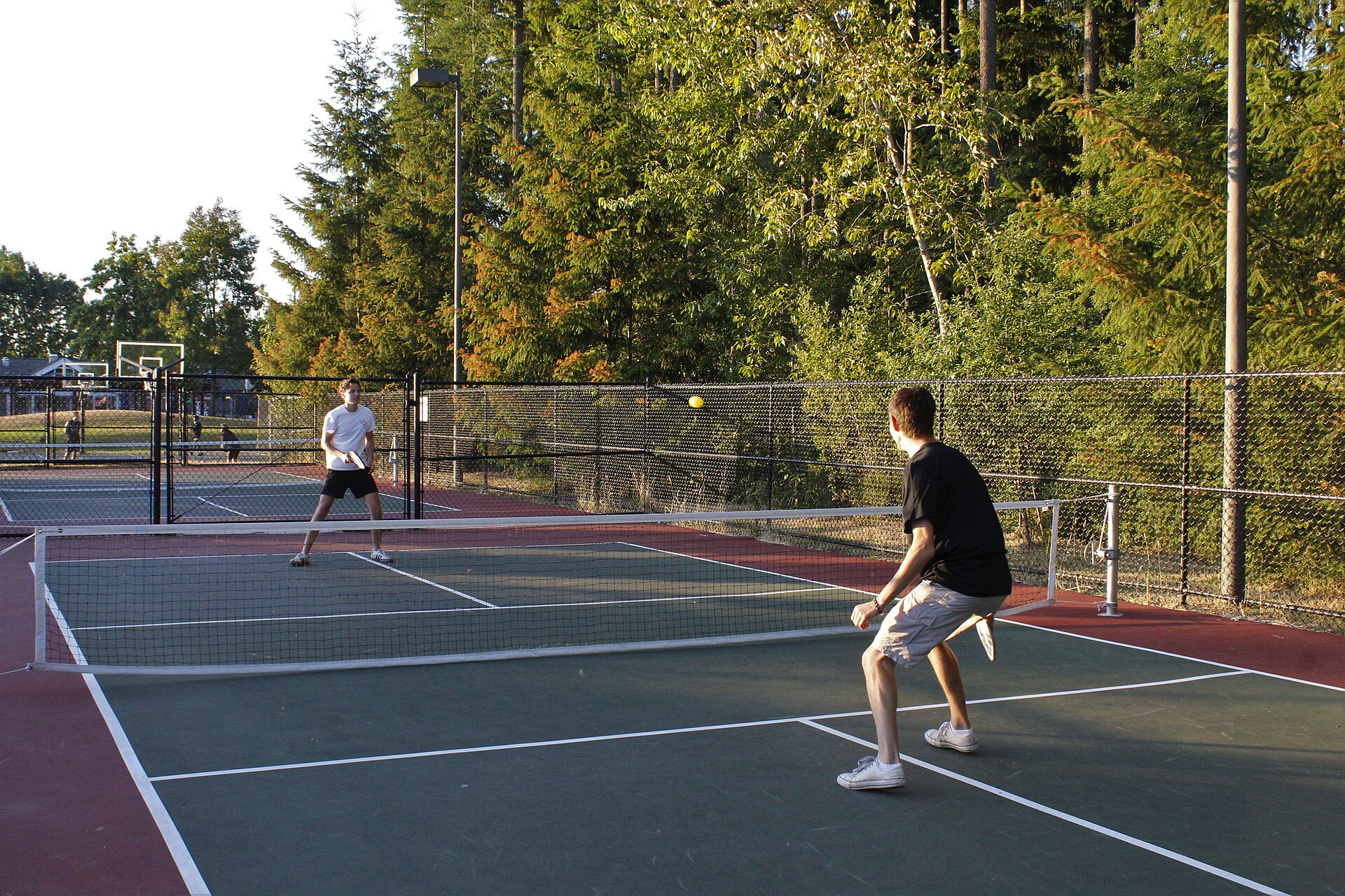 Two pickleball players competing at the net during a doubles match